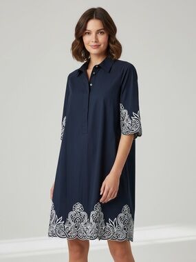 Navy shirt dress with cut out white embroidery at sleeves and hem. Chico’s 3.